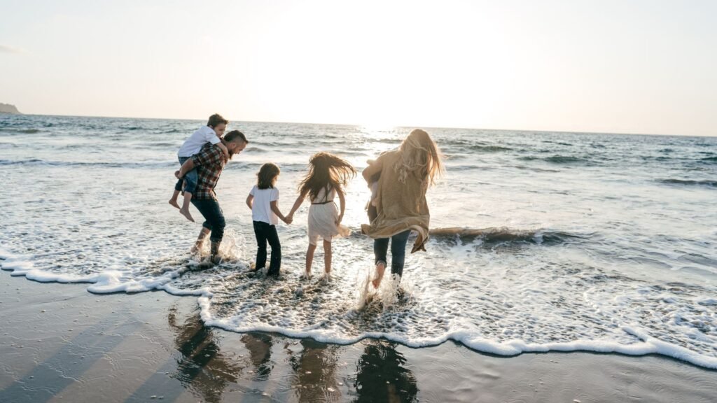 A family playing together by the shore